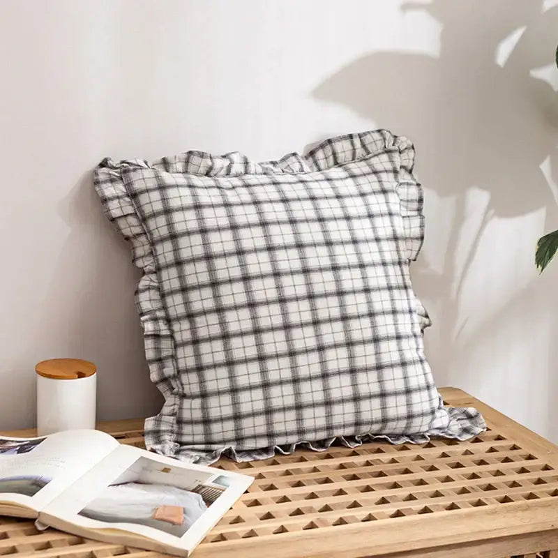 A soft black and white checkered cotton coffee black cushion cover with delicate ruffled edges for living room decor