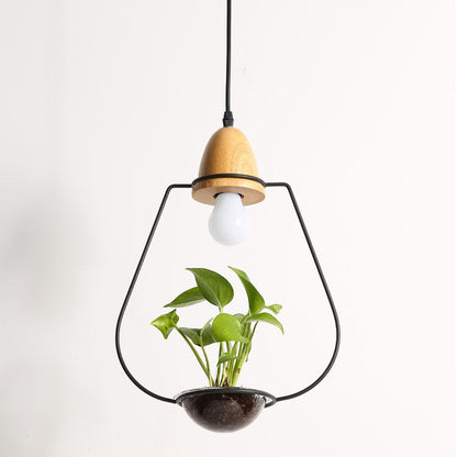 Pendant light with plant holder, black metal frame and wooden accents.