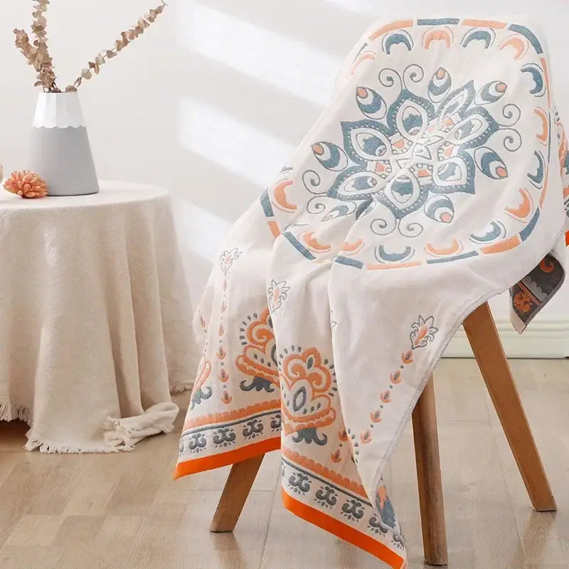 Off-white cotton bath towel with vibrant orange and teal mandala design from decorbites lions bath collection