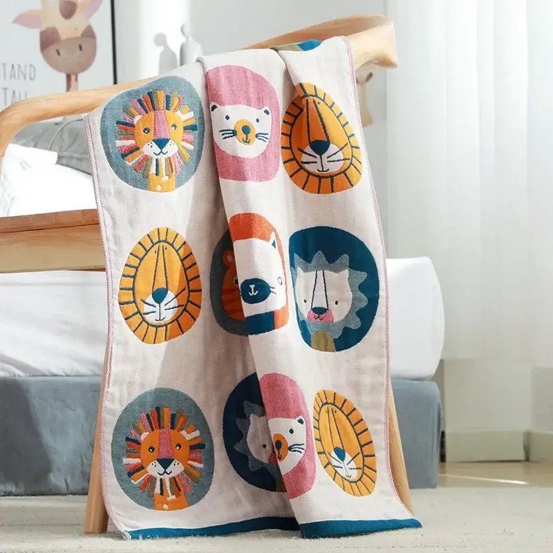 A soft cream-colored quick dry cotton bath towel with playful decorbites lions bath pattern of cartoon lions and cats