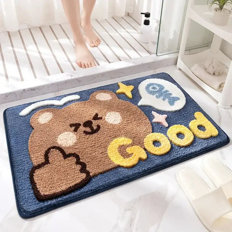Blue plush bath rug featuring a brown cartoon bear with thumbs-up and good lettering for decorbites cartoon animal bathroom use