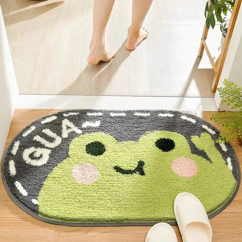 A plush green frog-themed bath rug with gray border and white lettering for decorbites cartoon animal bathroom use