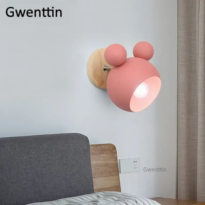 Pink matte-finish wall lamp with wooden base shaped like decorbites cartoon mouse for kids bedroom decor
