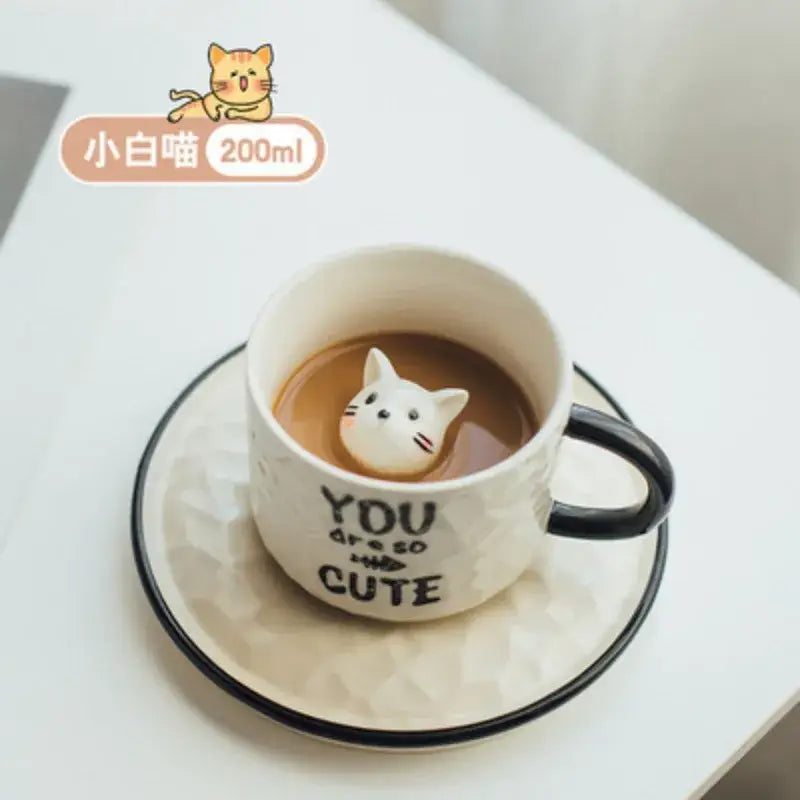 White ceramic cup with black handle featuring playful decorbites cat claw ceramic charm and you are so cute text