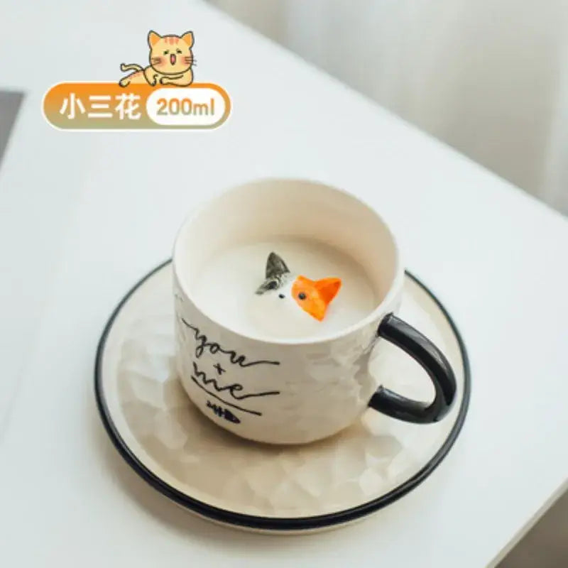 Playful white and black ceramic cup with decorbites cat claw figurines and you plus me script on textured surface
