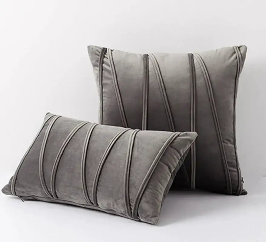 Set of two gray velvet throw pillows with vertical stitched stripes complementing short wool velvet decorbites knit short style