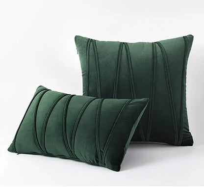Deep emerald green velvet throw pillows with elegant vertical pleated detailing complement knit short wool decorbites