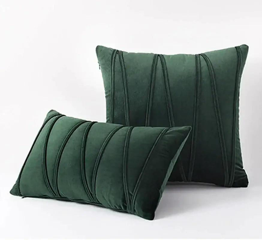 Deep emerald green velvet throw pillows with elegant vertical pleated detailing complement knit short wool decorbites