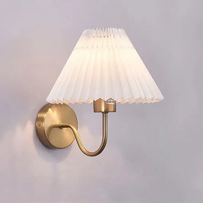 Pleated white cloth lampshade led wall lamp with brass finish and elegant curved arm for bedroom decorbites cloth lampshade