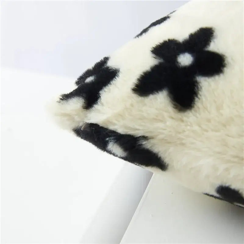 A plush cream-colored cushion cover with black white flower embroidered decorbites design for living room decor