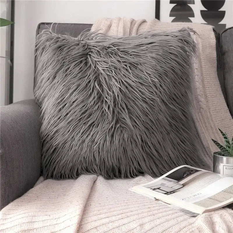 A plush square gray faux fur throw pillow with long shaggy fibers contrasting decorbites houndstooth cushion cover