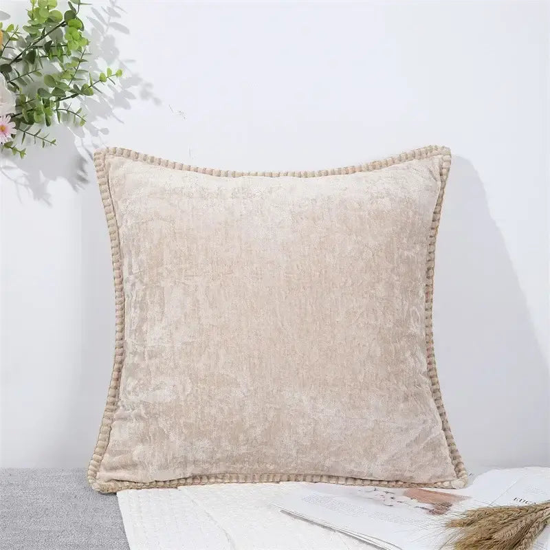 Beige velvet throw pillow with textured surface and pom-pom trim complementing decorbites houndstooth cushion cover