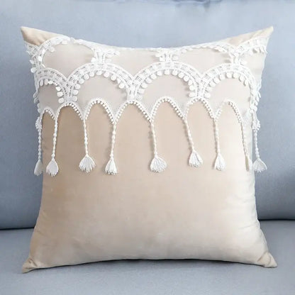 Beige velvet pillow with white lace trim and tassels complementing plush black and white decorbites houndstooth cushion cover