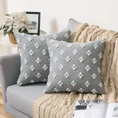 Plush black and white houndstooth cushion cover with gray throw pillows featuring white embroidered diamond patterns