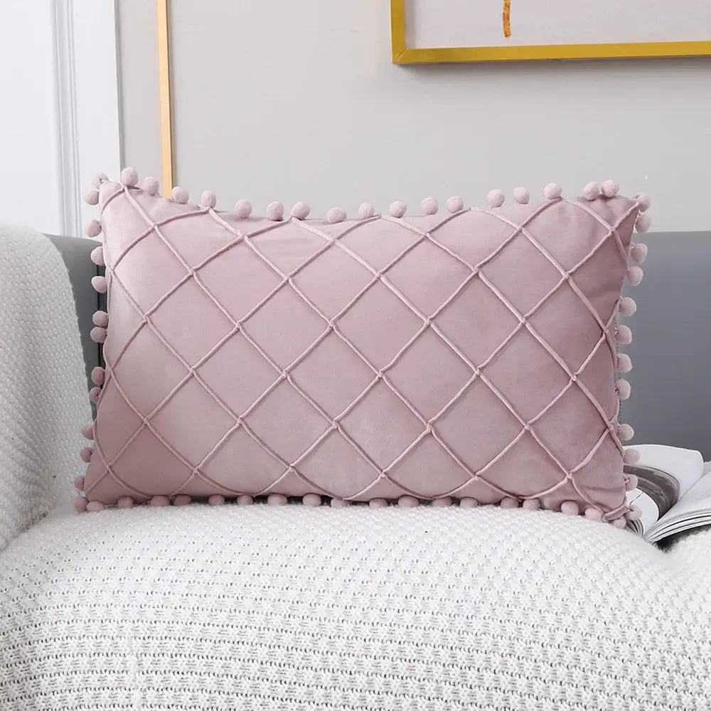 A soft pink velvet pillow with diamond lattice design and pom-poms complements the decorbites houndstooth cushion cover