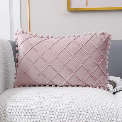 A soft pink velvet pillow with diamond lattice design and pom-poms complements the decorbites houndstooth cushion cover