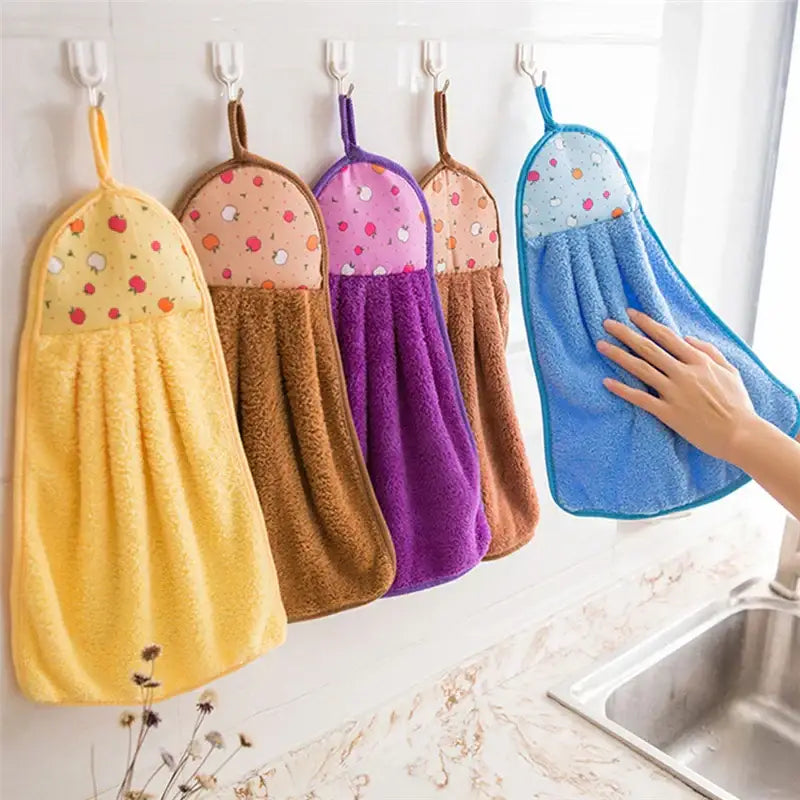 A set of plush colorful patterned coral velvet hand towels with soft terry cloth bottoms for kitchen use