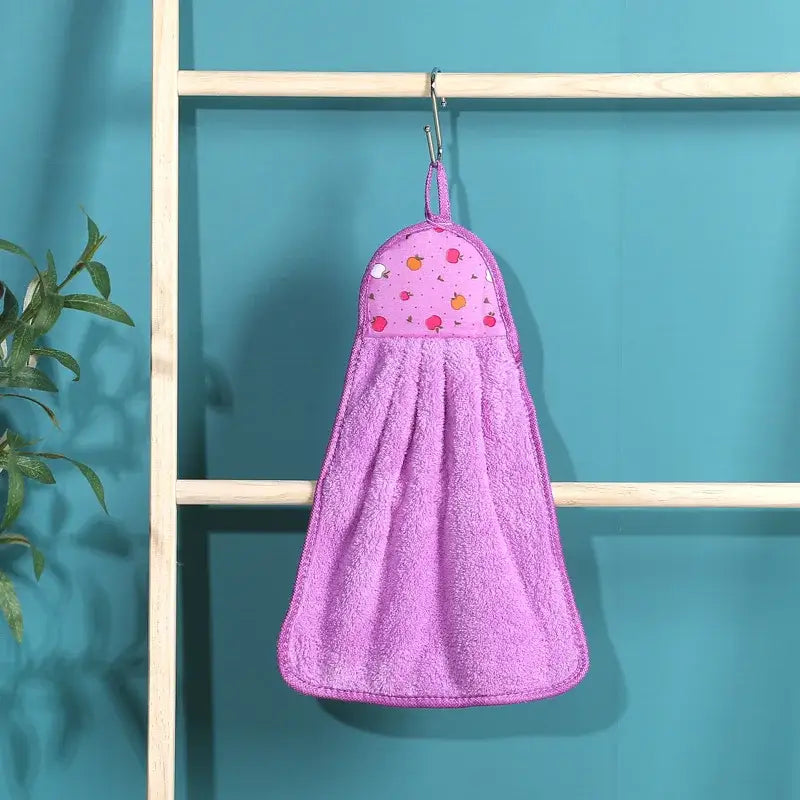 A soft pink plush colorful decorbites coral velvet hand towel with fruit-patterned top hanging on a hook