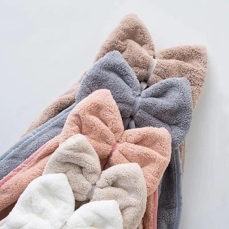A plush coral velvet soft hand towel with a fuzzy bow in pastel beige gray pink and white for kitchen and bathroom decorbites coral velvet