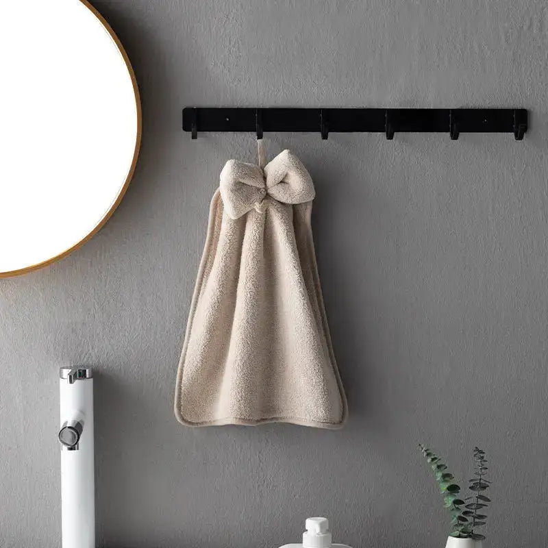 Beige plush hand towel with soft coral velvet texture and decorative bow for decorbites coral velvet kitchen and bathroom use