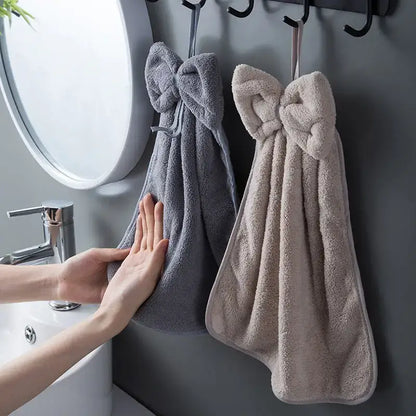 Gray and beige plush coral velvet soft hand towels with bow ties hanging on hooks for kitchen and bathroom decorbites coral velvet