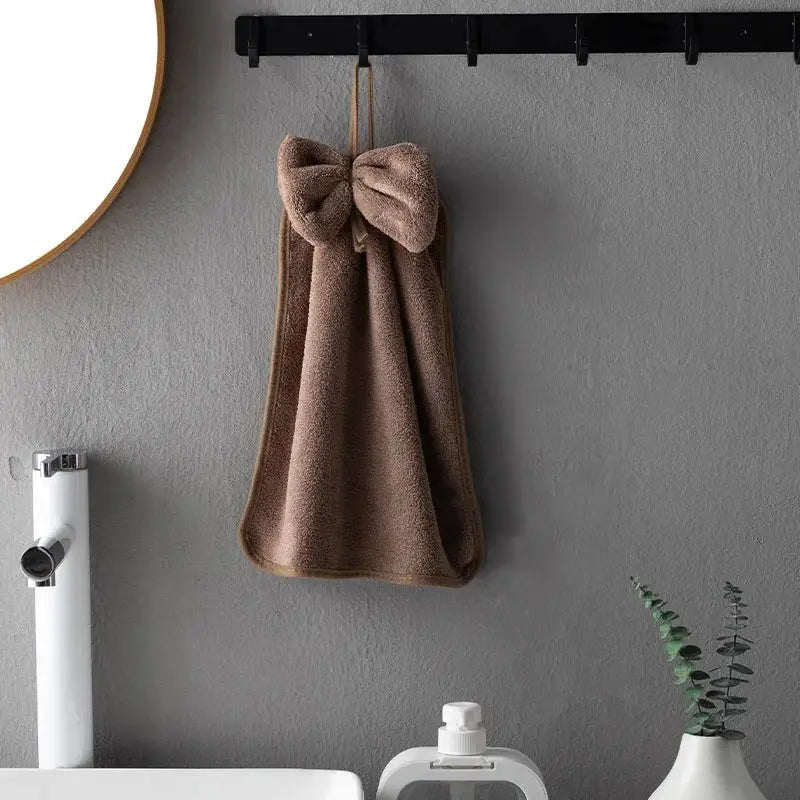A plush taupe coral velvet soft hand towel with a large bow, perfect for kitchen and bathroom decorbites coral velvet hand towels