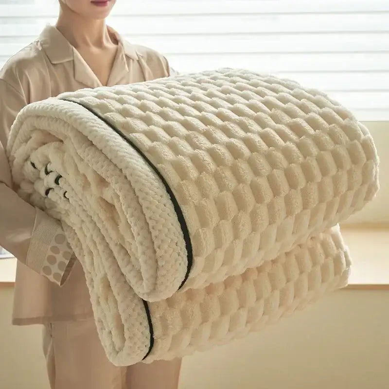 Cream-colored plush flannel fleece blanket with textured quilted pattern and black trim perfect for decorbites cozy flannel decor