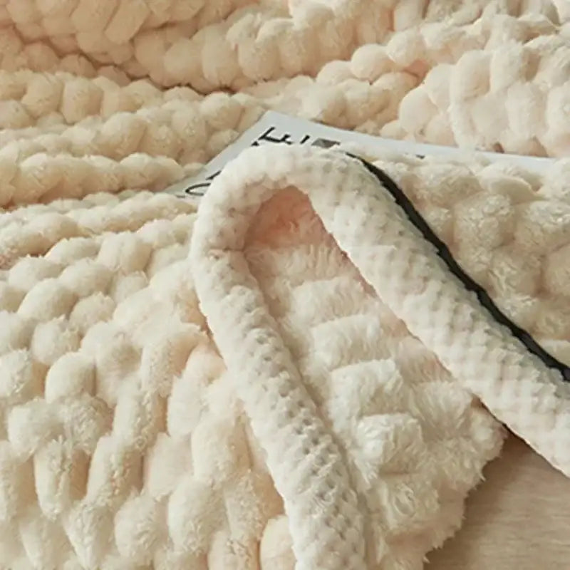 Cream-colored plush knitted throw blanket with chunky texture and cozy flannel fleece interior for bedroom decorbites cozy flannel