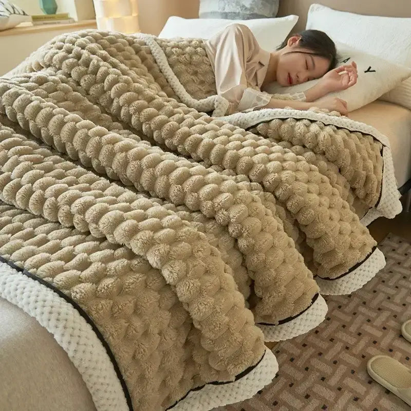 Beige plush cream and black textured flannel fleece blanket with raised pom-pom pattern and white knitted trim for cozy flannel decorbites