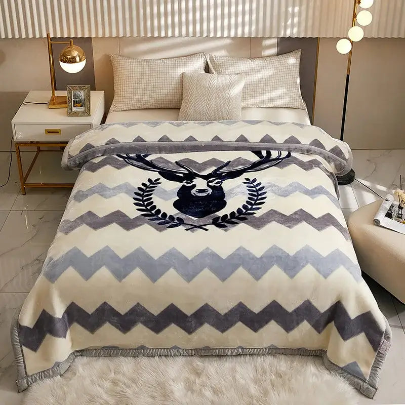 Cream-colored plush double layer raschel blanket with gray chevron pattern and black deer head emblem framed by laurel leaves