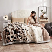 A plush cream and brown geometric double layer raschel throw blanket with soft faux fur texture for bedroom use
