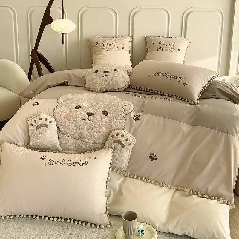 Beige plush cartoon bear applique cotton bedding set with embroidered paw prints and good luck message on pillows