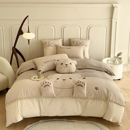 Cream-colored plush cotton bedding set featuring cartoon bear applique with soft textured fabric and embroidered details