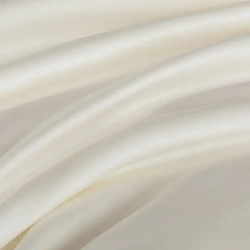 Plush cream cooling comforter made of silky soft satin fabric with a smooth glossy finish by decorbites cooling comforter