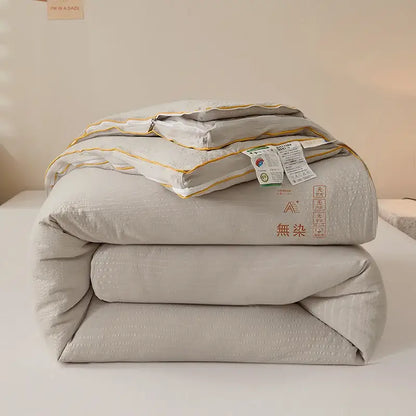 Plush cream cozy soy fiber quilt in soft light gray with subtle texture and gold piping for bedroom bedding decorbites cozy soy