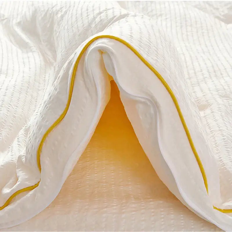 Plush cream cozy soy fiber quilt with white texture and yellow piping for bedroom bedding by decorbites cozy soy