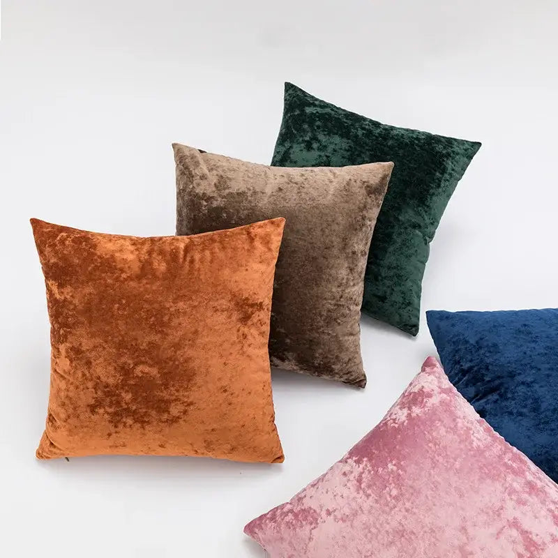 A collection of dark grain velvet pillow covers in earthy rust orange taupe brown deep green navy blue and dusty rose tones