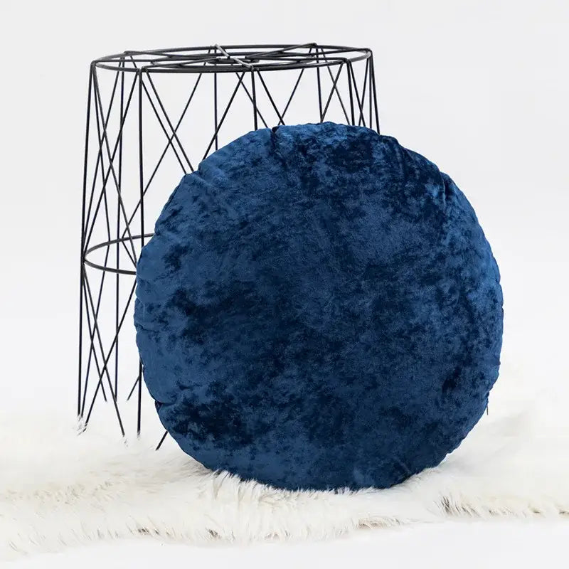 Deep blue velvet round pillow cover featuring a plush dark grain texture for elegant living room decor