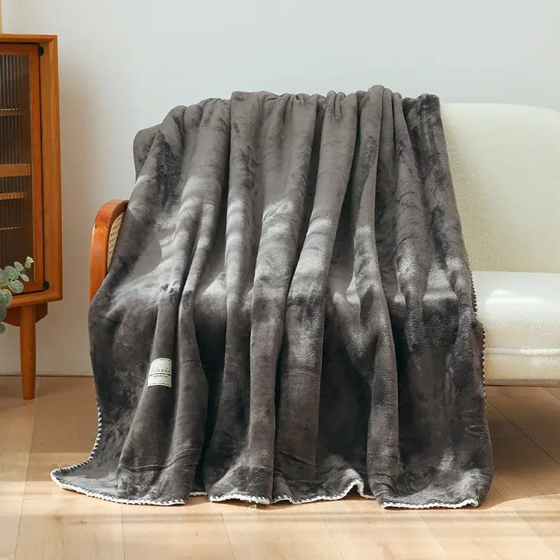 A plush dark gray double-layer warm blanket with soft velvety texture and white fringe trim for bedroom decor