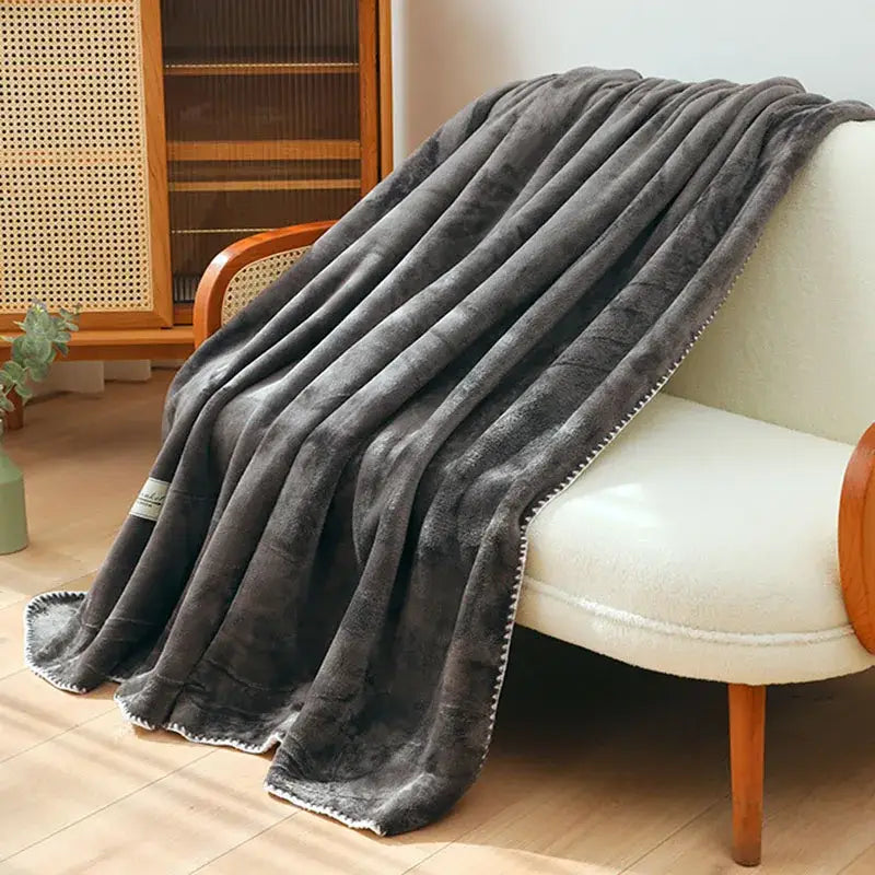 Plush dark gray double-layer warm blanket with soft velvety texture and white stitched trim for cozy decorbites use