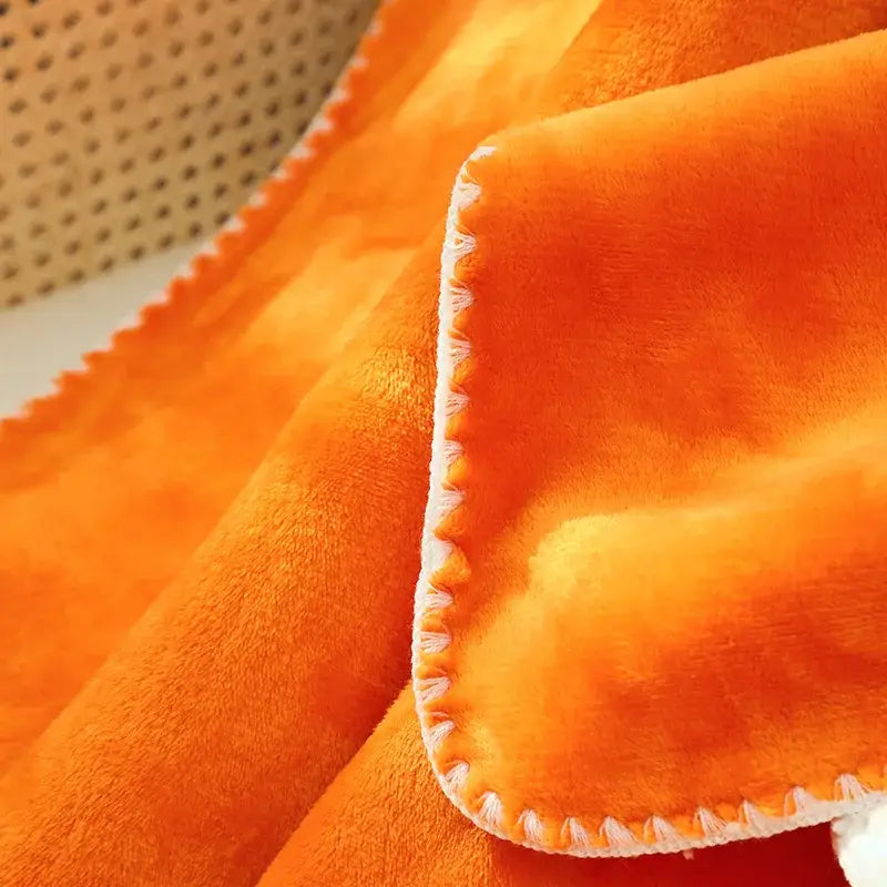 Vibrant orange plush decorbites double-layer warm blanket with soft fuzzy texture and white stitched edges for bedroom use