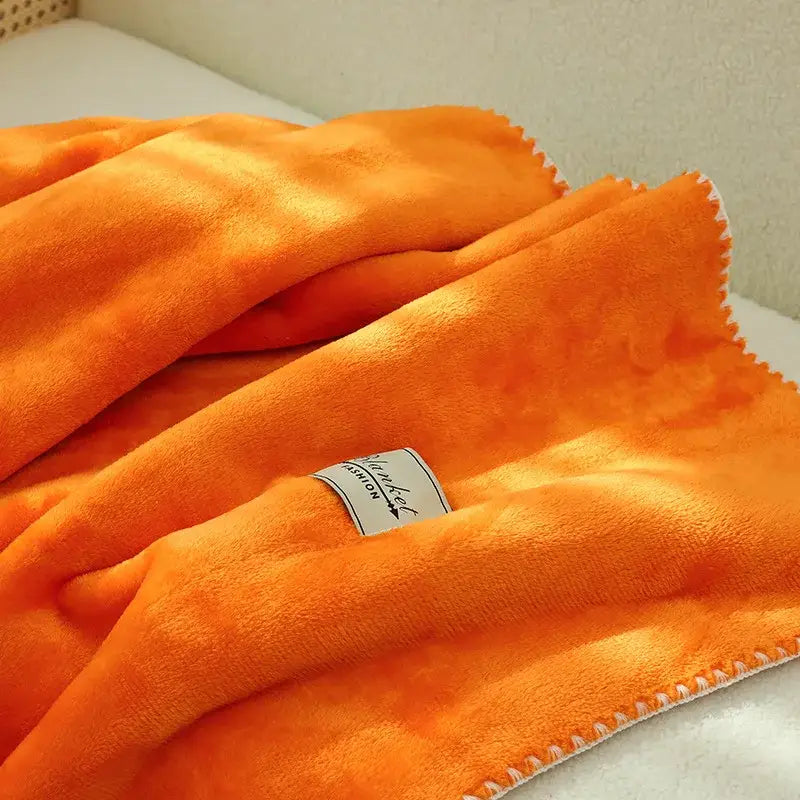 A plush orange fleece throw blanket with white stitched edges complements the decorbites double-layer warm blanket collection