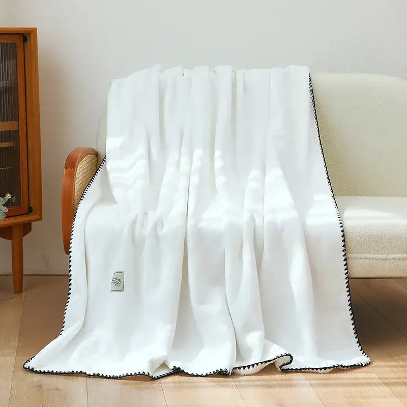 White plush double-layer warm blanket with black zigzag trim by decorbites for cozy bedroom use
