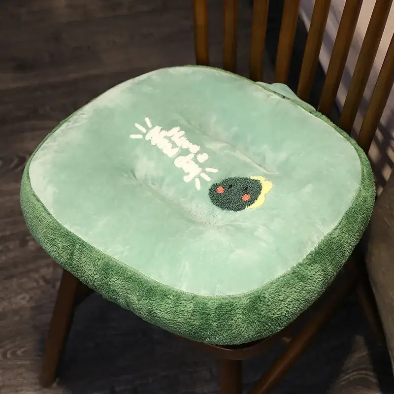 Soft mint-green plush chair cushion with embroidered avocado face and have a nice day text for cat shark cushion use