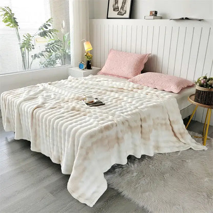 Cream-colored fleece throw blanket with textured wavy pattern and soft plush material for living room use