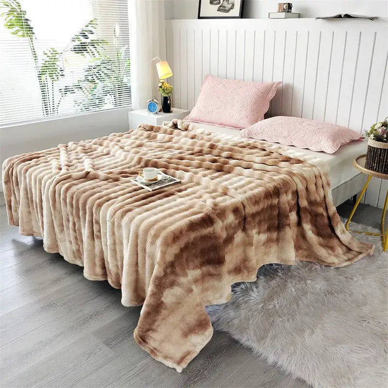 A plush fleece throw blanket with a soft beige and brown tie-dye pattern and chunky weave for living room use