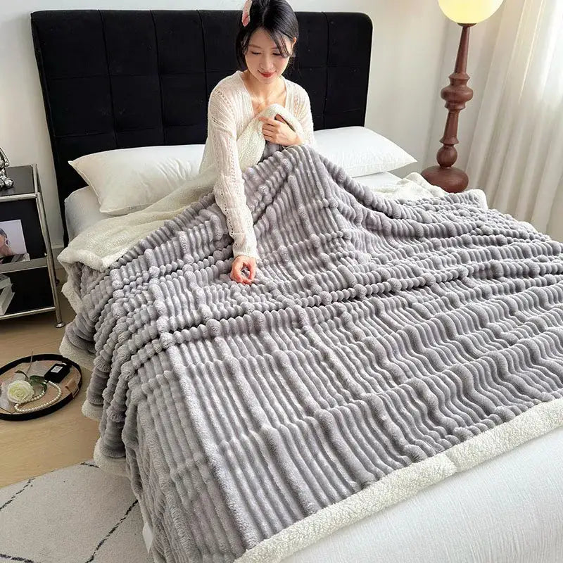 A plush gray and white ribbed sherpa blanket with cozy lamb wool and decorbites cozy lamb soft fleece border
