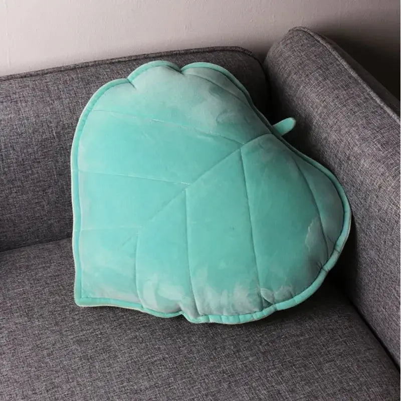 A soft mint green velvet leaf shaped throw pillow with stitched veins from decorbites 3d leaf collection for living room decor