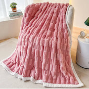 Plush pink bamboo velvet blanket with textured fuzzy surface and white braided trim for bedroom throw use