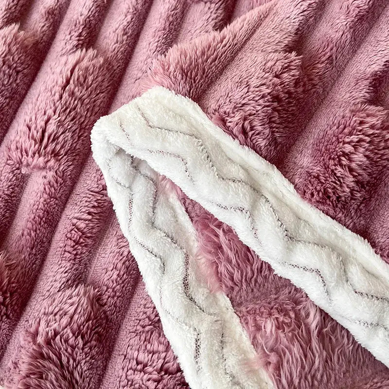 Plush pink bamboo velvet blanket with white zigzag-patterned braided trim for bedroom throw use